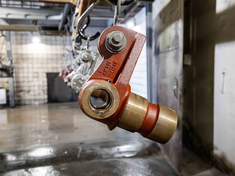 Machined pivot joint component with bronze bushing